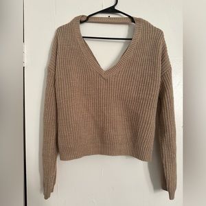 This sweater has a design on the back, and is in excellent condition.
